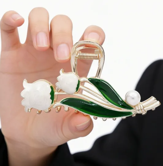 White Magnolia Hair Claw · Hand View